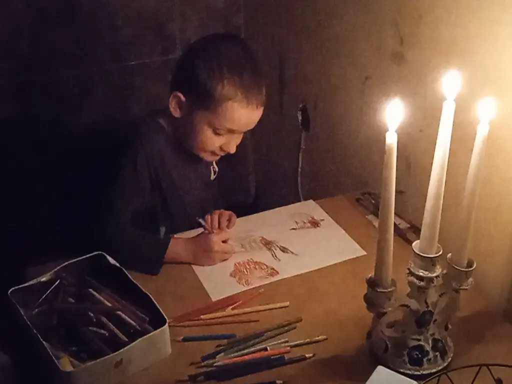 Timosha is drawing by the candles light